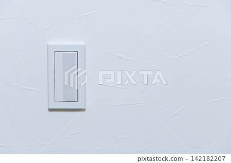 Light switch on a white wall 142182207