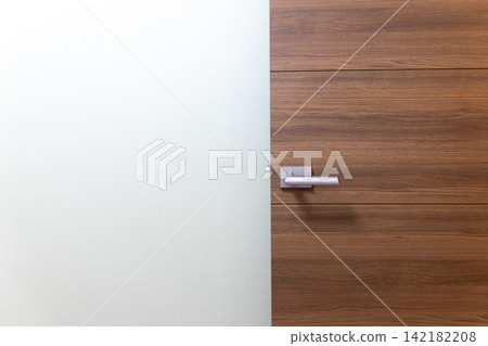 Modern wooden door with silver lever Modern wooden door with silver lever 142182208