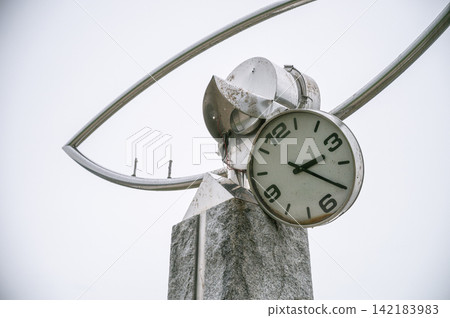 A close-up view of a clock monument whose hands stopped and became deformed around 3:25 due to tsunami damage. A close-up view of a clock monument whose hands stopped and became deformed around 3:25 due to tsunami damage. 142183983