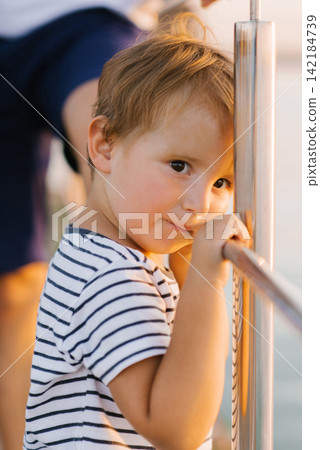 Cute Young Boy By The Lake At Sunset Cute Young Boy By The Lake At Sunset 142184739