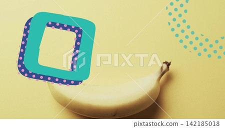 Ripe banana lying on yellow studio table, with turquoise square, purple dots and dotted semicircle Ripe banana lying on yellow studio table, with turquoise square, purple dots and dotted semicircle 142185018