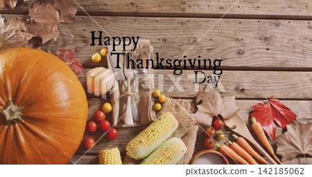 Orange pumpkin sitting left on rustic plank with cutlery, Happy Thanksgiving Day text, copy space Orange pumpkin sitting left on rustic plank with cutlery, Happy Thanksgiving Day text, copy space 142185062
