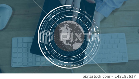 Holding tablet, hands in light blue shirt projecting AR globe over keyboard and mouse on desk Holding tablet, hands in light blue shirt projecting AR globe over keyboard and mouse on desk 142185637