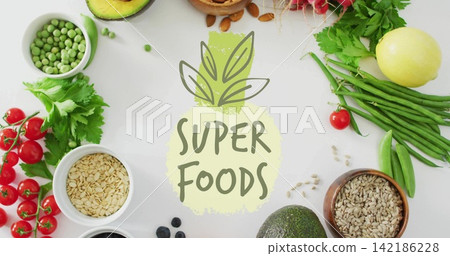 Arranging avocados, tomatoes, oats, almonds and seeds on white tabletop around SUPER FOODS label Arranging avocados, tomatoes, oats, almonds and seeds on white tabletop around SUPER FOODS label 142186228