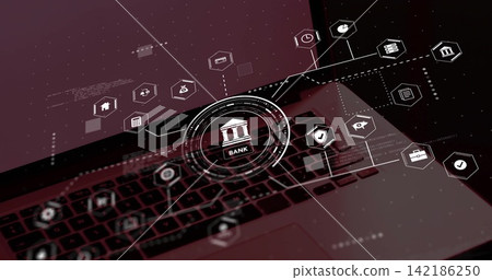 Displaying laptop keyboard and trackpad with glowing bank HUD and hex icons at workstation 142186250
