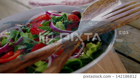 Showing white bowl holding greens tomatoes onions olives in kitchen with wood servers hologram map Showing white bowl holding greens tomatoes onions olives in kitchen with wood servers hologram map 142186812