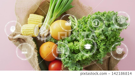 Spilling burlap sack showing kale corn onions oranges tomato cucumber on pink table with info icons Spilling burlap sack showing kale corn onions oranges tomato cucumber on pink table with info icons 142186814