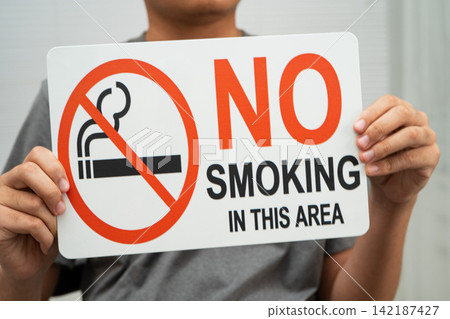 Male holding a no smoking sign. Male holding a no smoking sign. 142187427
