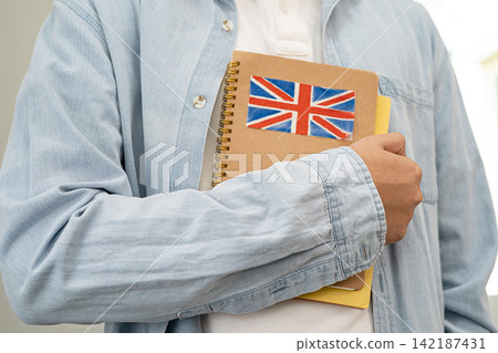 Learn English language, Asian teenage student hold book with flag in course at school. Learn English language, Asian teenage student hold book with flag in course at school. 142187431