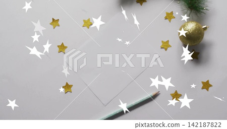 Placing centered blank card on white desk with mint pencil, gold stars, gold bauble, white stars 142187822