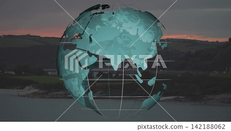 Floating stylized teal globe showing continents, gridlines over calm bay at sunset and rocky shore Floating stylized teal globe showing continents, gridlines over calm bay at sunset and rocky shore 142188062