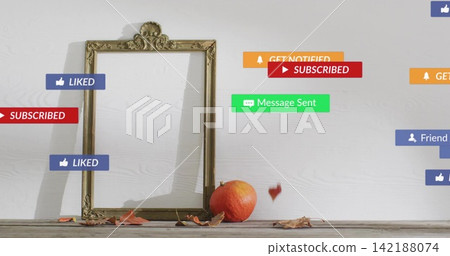 Ornate gold frame leaning on white panel wall on wood table, badges floating with pumpkin, leaves 142188074