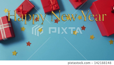 Showing gold Happy New Year lettering with red gift boxes on cyan-blue surface, scattering stars Showing gold Happy New Year lettering with red gift boxes on cyan-blue surface, scattering stars 142188148