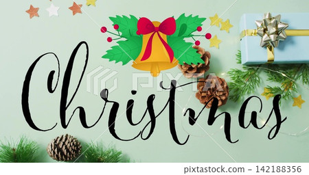 Displaying black script Christmas word on mint-green surface with golden bell, wrapped gift, lights Displaying black script Christmas word on mint-green surface with golden bell, wrapped gift, lights 142188356