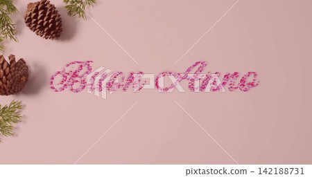 Displaying cursive Buon Anno using pink petals on pale pink sheet, with pine cones and sprigs Displaying cursive Buon Anno using pink petals on pale pink sheet, with pine cones and sprigs 142188731