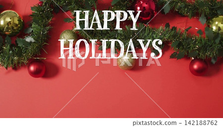 Vertical video: Showing light revealing HAPPY HOLIDAYS on red field, fir garland, baubles for cards Vertical video: Showing light revealing HAPPY HOLIDAYS on red field, fir garland, baubles for cards 142188762