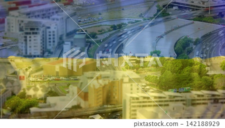 Showing aerial multilane interchange carrying traffic past river and trees with blue yellow bands Showing aerial multilane interchange carrying traffic past river and trees with blue yellow bands 142188929
