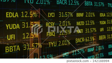 Showing Golden Gate Bridge towers glowing at night across bay, with stock tickers overlay 142188994