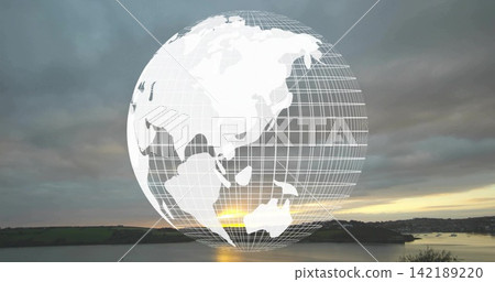 Glowing wireframe globe with continent grid covering coastal inlet horizon at sunset, over water Glowing wireframe globe with continent grid covering coastal inlet horizon at sunset, over water 142189220