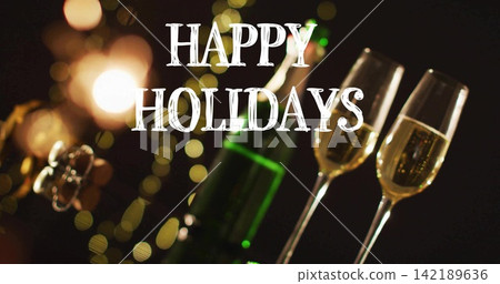 Showing green champagne bottle and two filled flutes on dim tabletop, with HAPPY HOLIDAYS text Showing green champagne bottle and two filled flutes on dim tabletop, with HAPPY HOLIDAYS text 142189636
