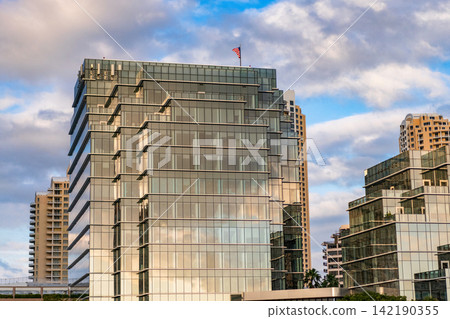 Modern glass building. Building in business city. City downtown architecture. Office building in city district. Brickell Key. Glass building architecture. Architectural glassy exterior Modern glass building. Building in business city. City downtown architecture. Office building in city district. Brickell Key. Glass building architecture. Architectural glassy exterior 142190355
