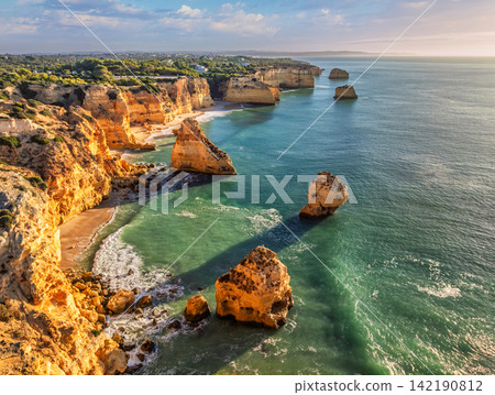 Praia da Marinha beach aerial ocean cliffs and sea stacks Algarve Portugal 142190812