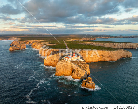 Drone view of Cabo de Sao Vicente lighthouse at sunset with tower light Drone view of Cabo de Sao Vicente lighthouse at sunset with tower light 142190828