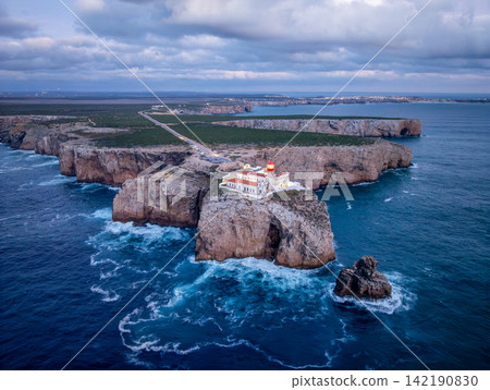 Drone view of Cabo de Sao Vicente lighthouse in evening over ocean texture 142190830