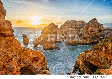 Ponte da Piedade sea stacks and ocean cliffs at sunrise in Lagos Ponte da Piedade sea stacks and ocean cliffs at sunrise in Lagos 142190832