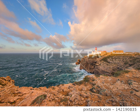 Cabo de Sao Vicente lighthouse at sunrise in a rocky coastal panorama Cabo de Sao Vicente lighthouse at sunrise in a rocky coastal panorama 142190835