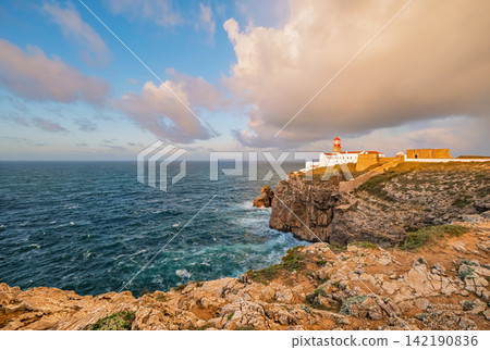 Cabo de Sao Vicente lighthouse at sunrise above open Atlantic water Cabo de Sao Vicente lighthouse at sunrise above open Atlantic water 142190836