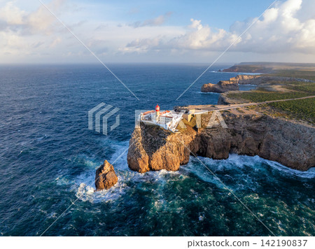 Drone view of Cabo de Sao Vicente lighthouse at sunrise on the coast Drone view of Cabo de Sao Vicente lighthouse at sunrise on the coast 142190837