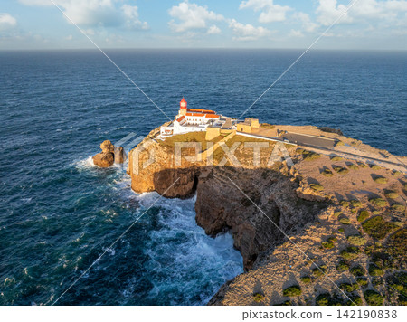 Drone view of Cabo de Sao Vicente lighthouse on sunrise sea cliffs 142190838