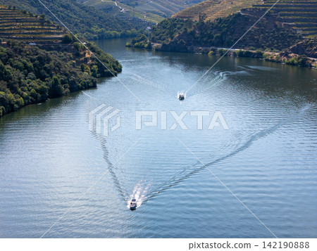 Douro River Boat Wake and Vineyard Valley in Portugal Daylight Douro River Boat Wake and Vineyard Valley in Portugal Daylight 142190888