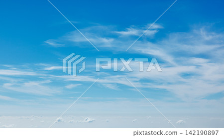 Clear blue sky with soft clouds creating a calming atmosphere during daytime Clear blue sky with soft clouds creating a calming atmosphere during daytime 142190897