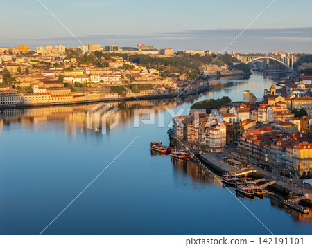 Drone view of Porto Ribeira and Douro River, Portugal, golden hour boats 142191101