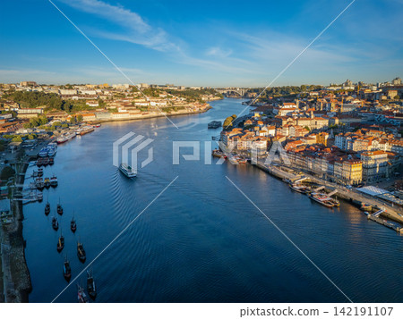 Drone View of tourist boat on Douro River between both sides Drone View of tourist boat on Douro River between both sides 142191107