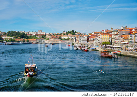 Tourist boat on Douro River by Ribeira Porto riverfront Tourist boat on Douro River by Ribeira Porto riverfront 142191117