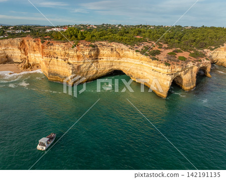 Drone View of a Tourist Tour Boat Near Benagil Cave Drone View of a Tourist Tour Boat Near Benagil Cave 142191135