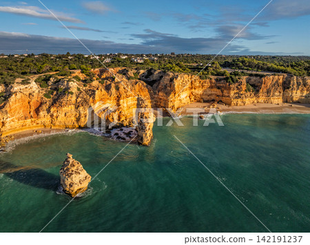 Praia da Marinha beach sweeping ocean cliffs and sea stacks Algarve Portugal Praia da Marinha beach sweeping ocean cliffs and sea stacks Algarve Portugal 142191237