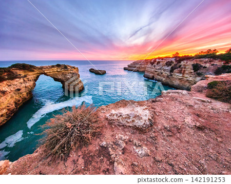 Dramatic Sunset at Arco de Albandeira Beside Sunset Clouds Dramatic Sunset at Arco de Albandeira Beside Sunset Clouds 142191253