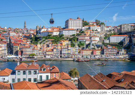 Teleferico de Gaia cable car with Douro boats above the river scene Teleferico de Gaia cable car with Douro boats above the river scene 142191323