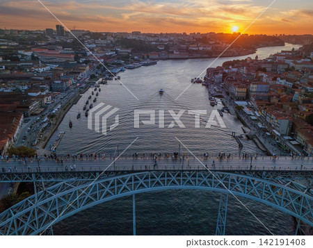 Drone View of Dom Luis I Bridge and tourist boat at sunset Drone View of Dom Luis I Bridge and tourist boat at sunset 142191408