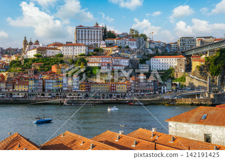 Porto Ribeira Portugal over Douro River rooftops with Dom Luis I Bridge Porto Ribeira Portugal over Douro River rooftops with Dom Luis I Bridge 142191425