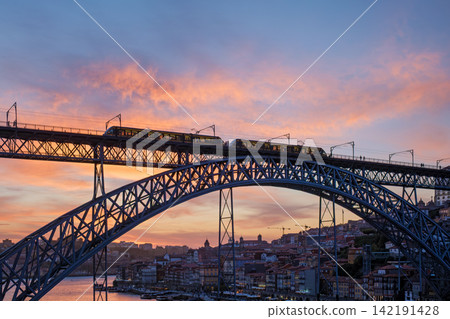 Tram on Dom Luis I Bridge in Porto at dramatic sunset Tram on Dom Luis I Bridge in Porto at dramatic sunset 142191428