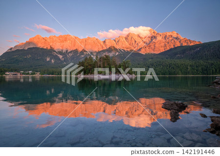 Twilight glow at Eibsee lake with Zugspitze mountain and island reflection Twilight glow at Eibsee lake with Zugspitze mountain and island reflection 142191446