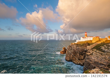 Cabo de Sao Vicente lighthouse at sunrise across the Atlantic coast Cabo de Sao Vicente lighthouse at sunrise across the Atlantic coast 142191574