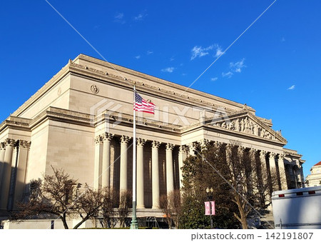 The National Archives Building in Washington, features a neoclassical facade with a Corinthian colonnade, a monumental pediment, and bas-reliefs The National Archives Building in Washington, features a neoclassical facade with a Corinthian colonnade, a monumental pediment, and bas-reliefs 142191807