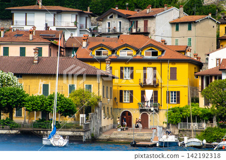 Yellow house wall facade. Old villa Village on a Green Hillside on Lake Como, Italy. Italian architecture 142192318