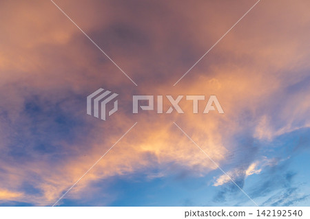 A fantastic summer scene with bright sunset clouds spreading across the sky. A fantastic summer scene with bright sunset clouds spreading across the sky. 142192540